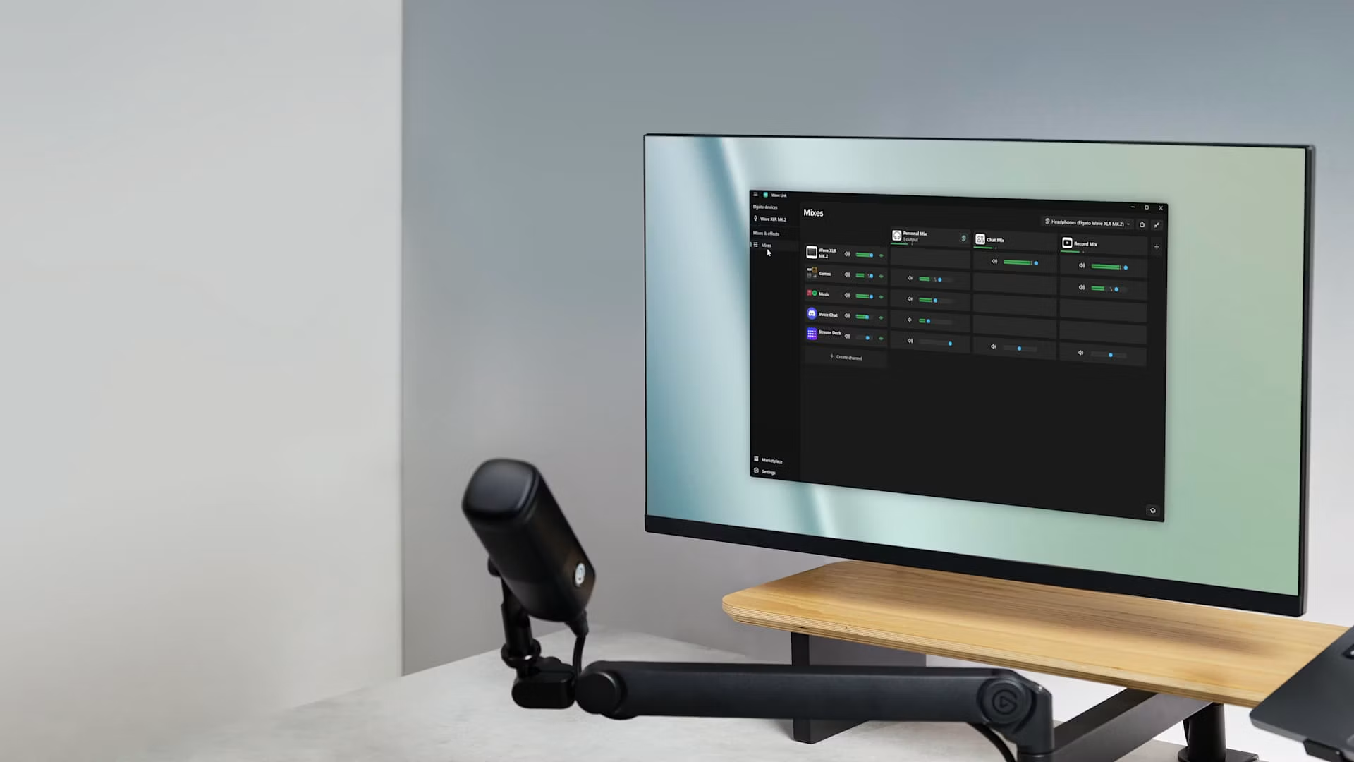 Minimal bright desk with a monitor on a wooden riser running WaveXLR mixes and a microphone on a boom arm
