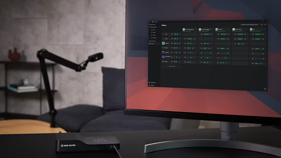 Moody living-room setup with a Wave XLR Pro interface beside a monitor showing the mixes grid